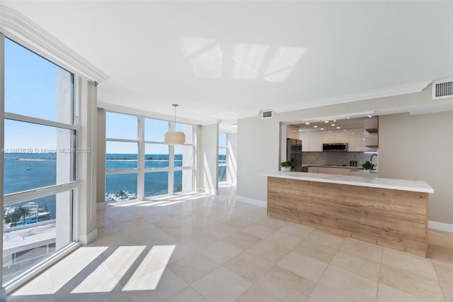 1901 Brickell Ave Unit B1114, Miami, FL 33129 - kitchen featuring appliances with stainless steel finishes, a water view, modern cabinets, crown molding, and light tile patterned floors