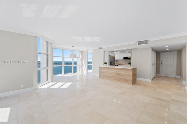 1901 Brickell Ave Unit B1114, Miami, FL 33129 - unfurnished living room featuring a water view, a wall of windows, light tile patterned floors, and crown molding