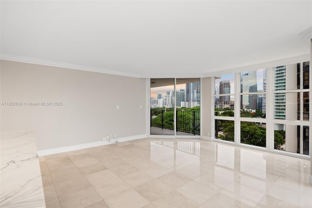 1901 Brickell Ave Unit B1114, Miami, FL 33129 - empty room featuring a wall of windows, a city view, crown molding, and light tile patterned floors