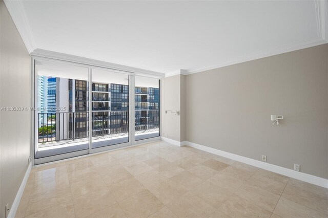 1901 Brickell Ave Unit B1114, Miami, FL 33129 - empty room with healthy amount of natural light, baseboards, crown molding, a wall of windows, and light tile patterned flooring