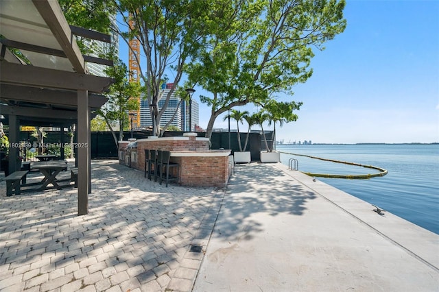 1901 Brickell Ave Unit B1114, Miami, FL 33129 - view of patio featuring a water view and an outdoor kitchen