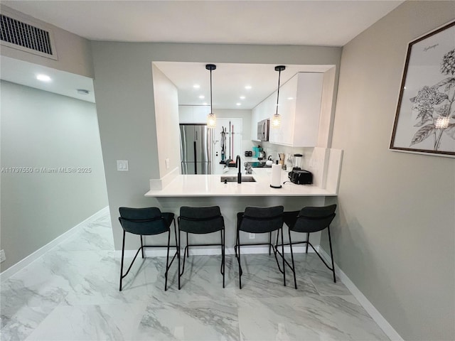 3725 S Ocean Dr Unit 425, Hollywood, FL 33019 - kitchen with appliances with stainless steel finishes, a kitchen breakfast bar, light marble finish flooring, a peninsula, and recessed lighting