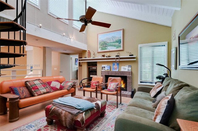 3169 Via Abitare Way Unit 6, Miami, FL 33133 - living room with wood finished floors, a brick fireplace, high vaulted ceiling, beamed ceiling, and a ceiling fan