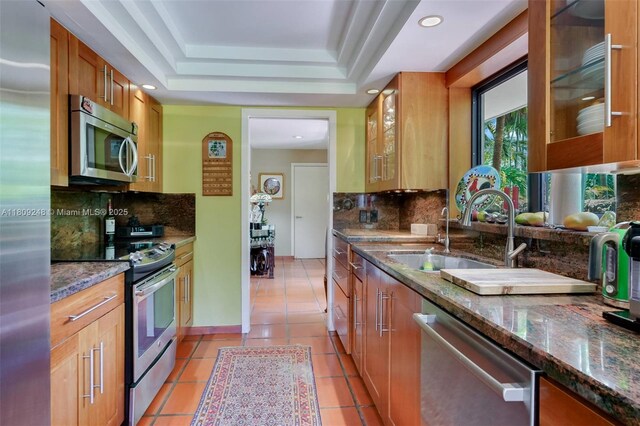 3169 Via Abitare Way Unit 6, Miami, FL 33133 - kitchen with appliances with stainless steel finishes, a sink, backsplash, dark stone counters, and recessed lighting