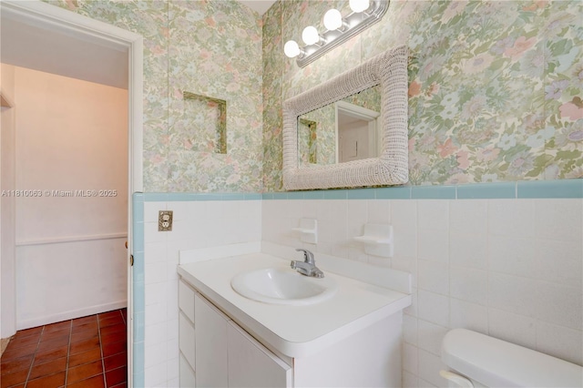 7211 Plantation Blvd, Miramar, FL 33023 - bathroom featuring wallpapered walls, a wainscoted wall, vanity, tile patterned flooring, and tile walls