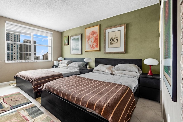 1985 S Ocean Dr Unit 17D, Hallandale Beach, FL 33009 - tiled bedroom featuring a textured ceiling and baseboards