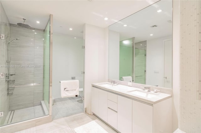 16901 Collins Ave Unit 2504, Sunny Isles Beach, FL 33160 - bathroom with a stall shower, double vanity, toilet, and recessed lighting