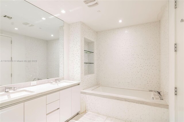 16901 Collins Ave Unit 2504, Sunny Isles Beach, FL 33160 - full bathroom featuring a garden tub, double vanity, and recessed lighting