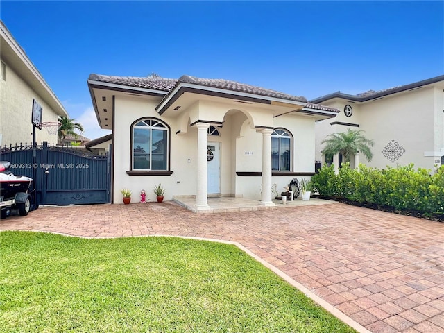 15333 SW 40th Ter, Miami, FL 33185 - mediterranean / spanish-style home with stucco siding, a tile roof, and a front yard