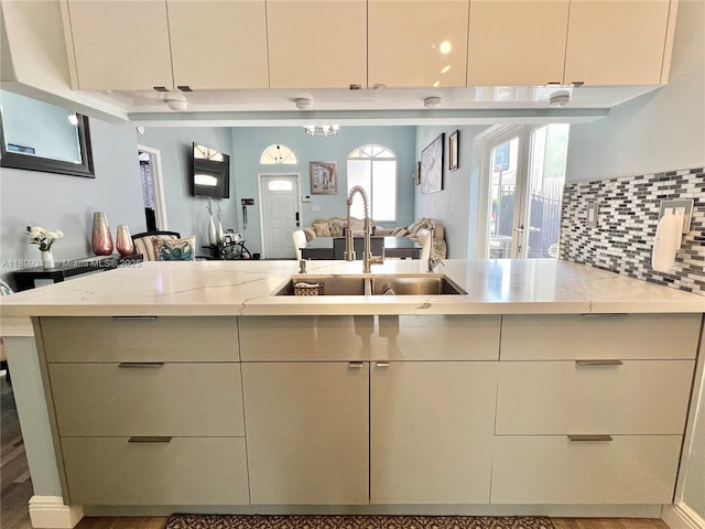 15333 SW 40th Ter, Miami, FL 33185 - kitchen featuring a sink, open floor plan, light stone countertops, modern cabinets, and backsplash