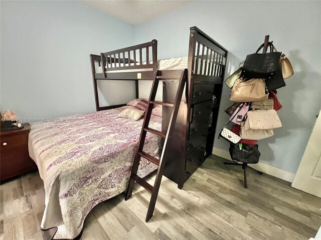 15333 SW 40th Ter, Miami, FL 33185 - bedroom featuring wood finished floors, a textured ceiling, and baseboards