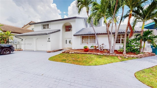 19140 N Bay Rd, Sunny Isles Beach, FL 33160 - mediterranean / spanish house featuring decorative driveway, stucco siding, and an attached garage