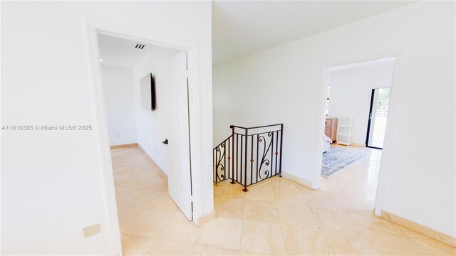 19140 N Bay Rd, Sunny Isles Beach, FL 33160 - hall with an upstairs landing, light tile patterned floors, and baseboards