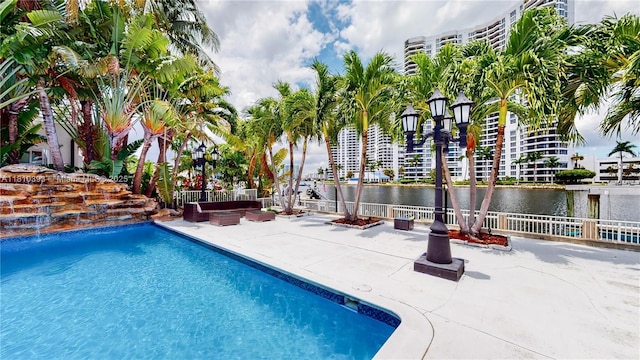 19140 N Bay Rd, Sunny Isles Beach, FL 33160 - swimming pool featuring a patio area, a water view, and outdoor lounge area
