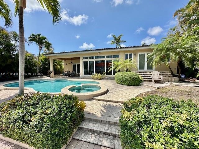 1945 N Hibiscus Dr, North Miami, FL 33181 - view of pool with a patio, french doors, and a pool with connected hot tub