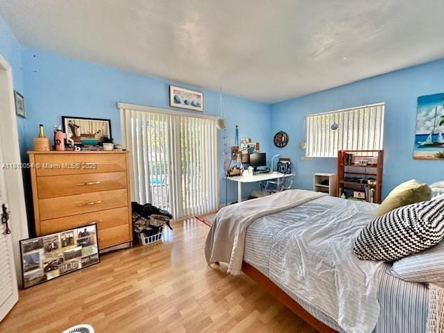 1945 N Hibiscus Dr, North Miami, FL 33181 - bedroom with access to exterior and wood finished floors