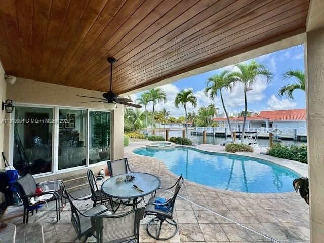 1945 N Hibiscus Dr, North Miami, FL 33181 - view of swimming pool with a patio, a ceiling fan, and a pool with connected hot tub