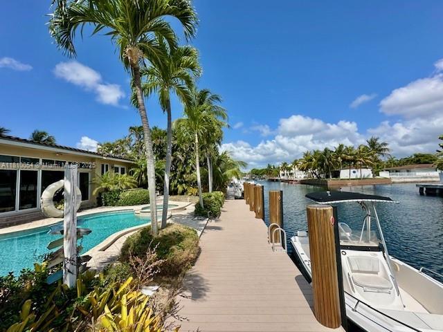 1945 N Hibiscus Dr, North Miami, FL 33181 - swimming pool featuring a boat dock and a water view