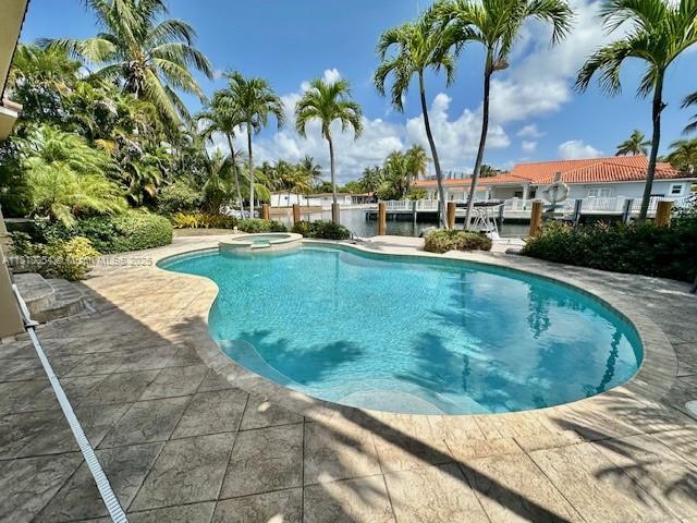 1945 N Hibiscus Dr, North Miami, FL 33181 - view of pool featuring a pool with connected hot tub and a patio area