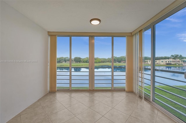 9450 Poinciana Pl Unit 212, Davie, FL 33324 - unfurnished sunroom featuring a water view, tile patterned flooring, and plenty of natural light