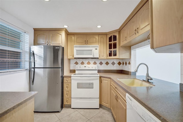 9450 Poinciana Pl Unit 212, Davie, FL 33324 - kitchen featuring white appliances, a sink, light brown cabinetry, glass insert cabinets, and tasteful backsplash