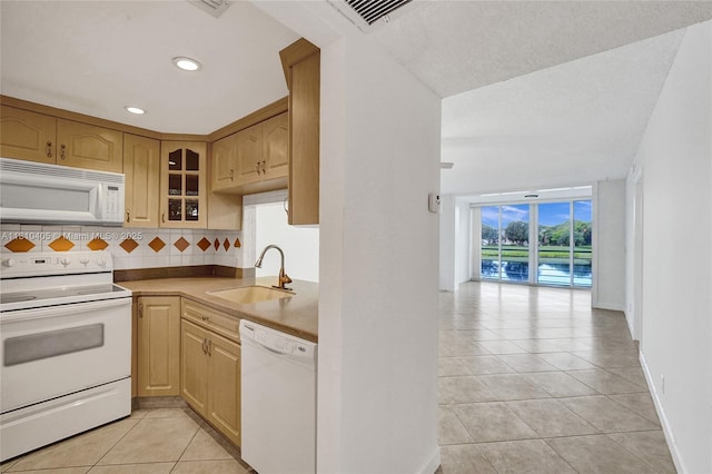 9450 Poinciana Pl Unit 212, Davie, FL 33324 - kitchen with white appliances, a sink, light tile patterned flooring, decorative backsplash, and recessed lighting