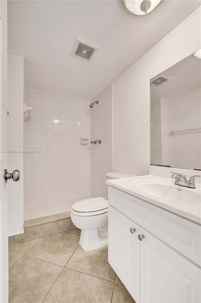 9450 Poinciana Pl Unit 212, Davie, FL 33324 - bathroom with vanity, tiled shower, tile patterned floors, and toilet