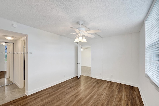 9450 Poinciana Pl Unit 212, Davie, FL 33324 - unfurnished room with wood finished floors, a ceiling fan, a smoke detector, a textured ceiling, and baseboards