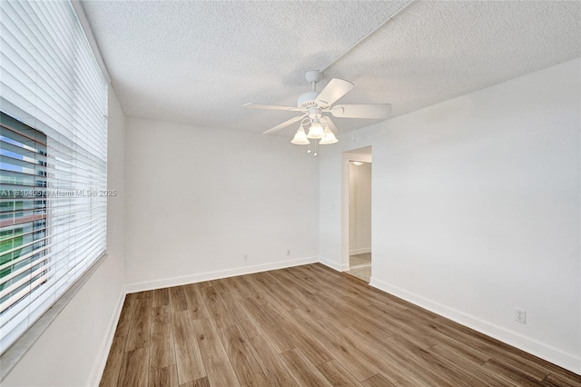 9450 Poinciana Pl Unit 212, Davie, FL 33324 - empty room with wood finished floors, a ceiling fan, a textured ceiling, and baseboards