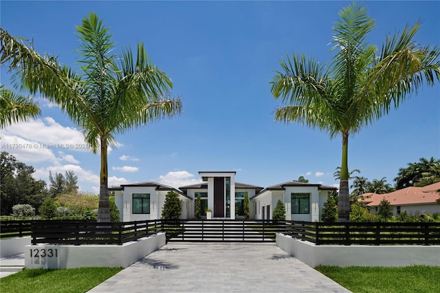 12331 SW 2nd St, Plantation, FL 33325 - contemporary home featuring a fenced front yard, stucco siding, and a gate