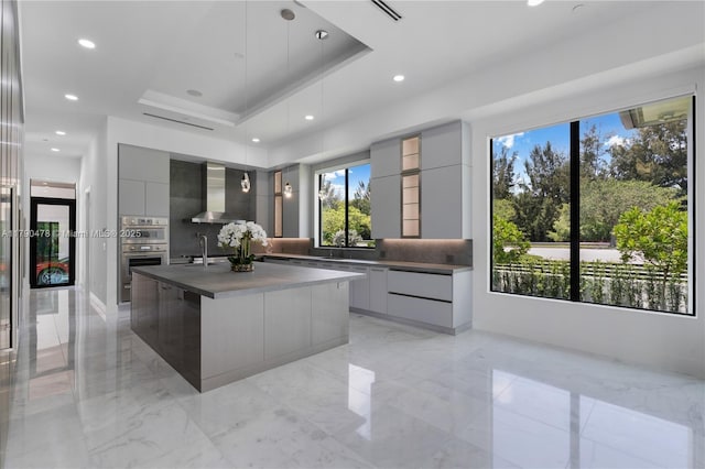 12331 SW 2nd St, Plantation, FL 33325 - kitchen with modern cabinets, wall chimney range hood, gray cabinets, tasteful backsplash, and recessed lighting