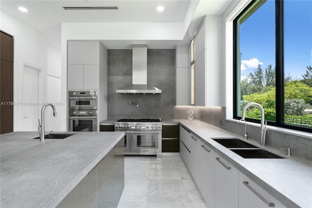12331 SW 2nd St, Plantation, FL 33325 - kitchen with wall chimney range hood, appliances with stainless steel finishes, a sink, modern cabinets, and recessed lighting