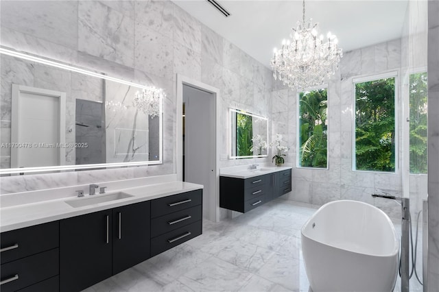 12331 SW 2nd St, Plantation, FL 33325 - bathroom with tile walls, two vanities, a chandelier, and a freestanding bath