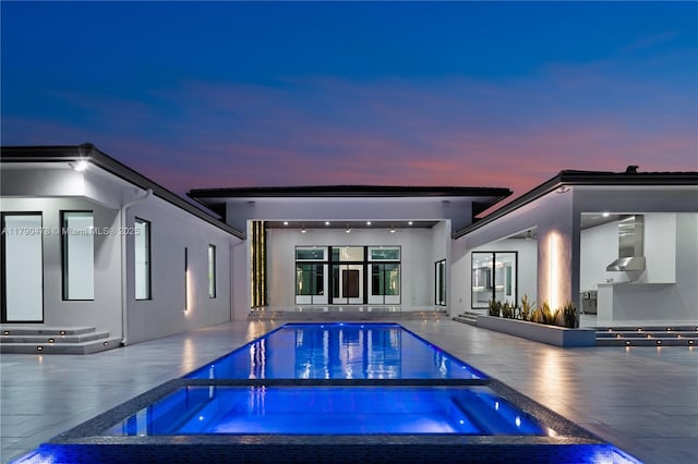 12331 SW 2nd St, Plantation, FL 33325 - back of house featuring an in-ground hot tub, a patio area, stucco siding, and an outdoor pool