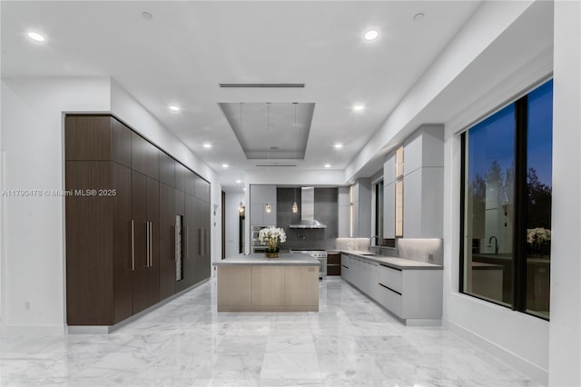 12331 SW 2nd St, Plantation, FL 33325 - kitchen with modern cabinets, wall chimney exhaust hood, light countertops, light marble finish flooring, and recessed lighting
