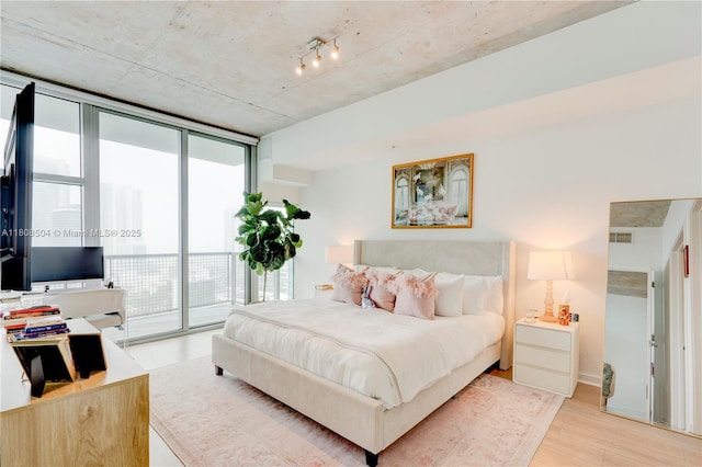 3301 NE 1st Ave Unit H2304, Miami, FL 33137 - bedroom with access to exterior, light wood-style flooring, and expansive windows