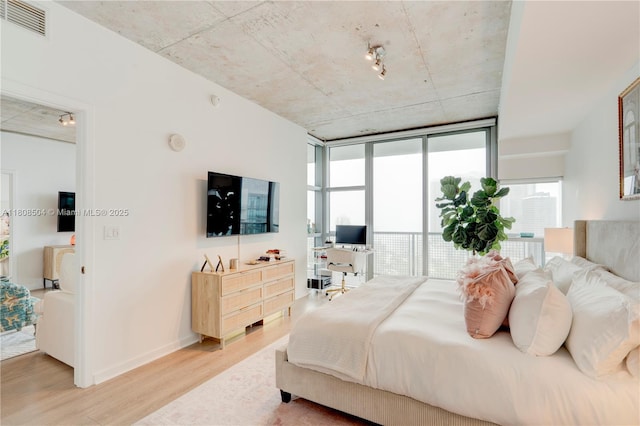 3301 NE 1st Ave Unit H2304, Miami, FL 33137 - bedroom with light wood-style flooring, multiple windows, and expansive windows