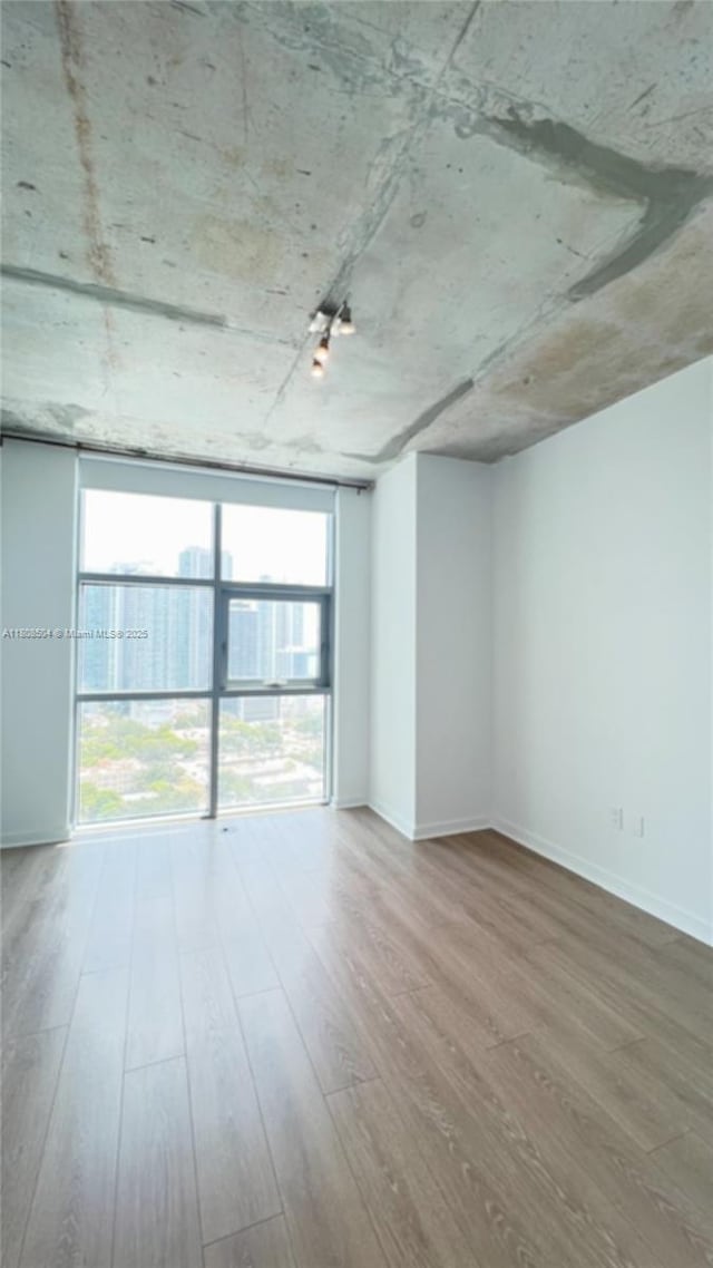 3301 NE 1st Ave Unit H2304, Miami, FL 33137 - unfurnished room featuring wood finished floors and baseboards
