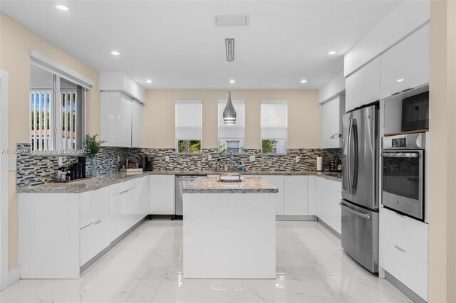 1930 SW 12th Ave, Miami, FL 33129 - kitchen featuring stainless steel appliances, modern cabinets, decorative backsplash, white cabinetry, and recessed lighting