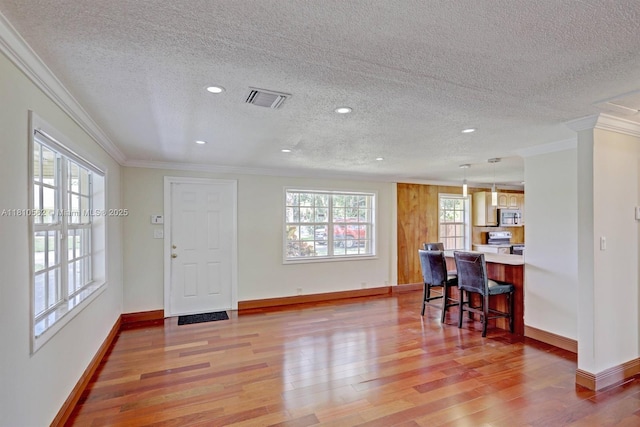 5156 Hartwick Ln, West Palm Beach, FL 33415 - interior space with ornamental molding, light wood-type flooring, a textured ceiling, baseboards, and recessed lighting