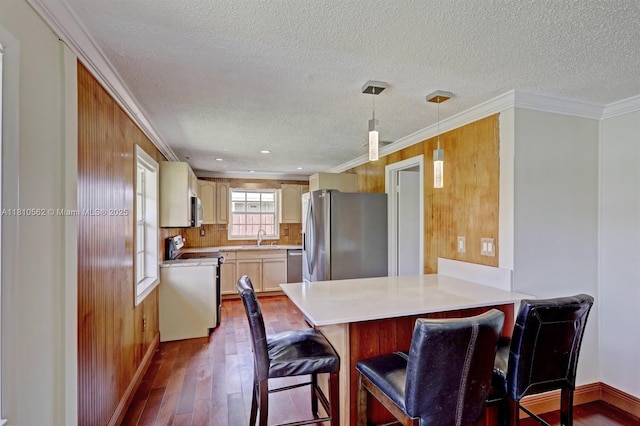 5156 Hartwick Ln, West Palm Beach, FL 33415 - kitchen featuring stainless steel appliances, a sink, dark wood finished floors, a peninsula, and a textured ceiling