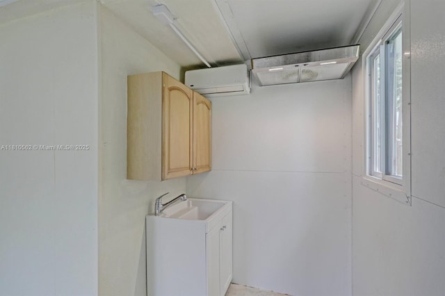 5156 Hartwick Ln, West Palm Beach, FL 33415 - laundry area with a wall mounted AC, plenty of natural light, and a sink