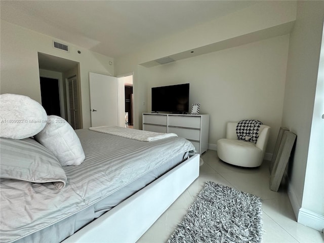 950 Brickell Bay Dr Unit 2607, Miami, FL 33131 - bedroom with baseboards, light tile patterned flooring, and a closet