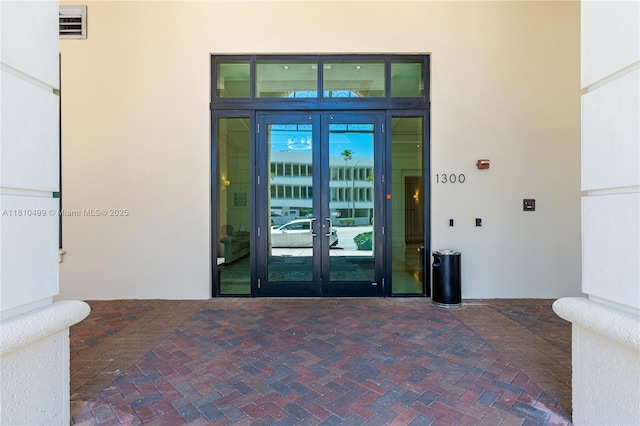 1300 Ponce De Leon Blvd Unit 705, Coral Gables, FL 33134 - doorway to property with french doors and stucco siding