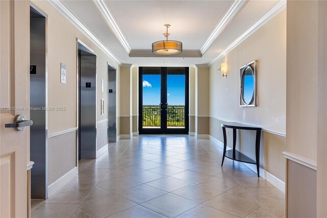 1300 Ponce De Leon Blvd Unit 705, Coral Gables, FL 33134 - interior space featuring french doors, a raised ceiling, light tile patterned floors, elevator, and ornamental molding
