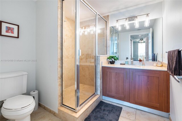 1300 Ponce De Leon Blvd Unit 705, Coral Gables, FL 33134 - full bath featuring toilet, vanity, tile patterned floors, a stall shower, and ceiling fan