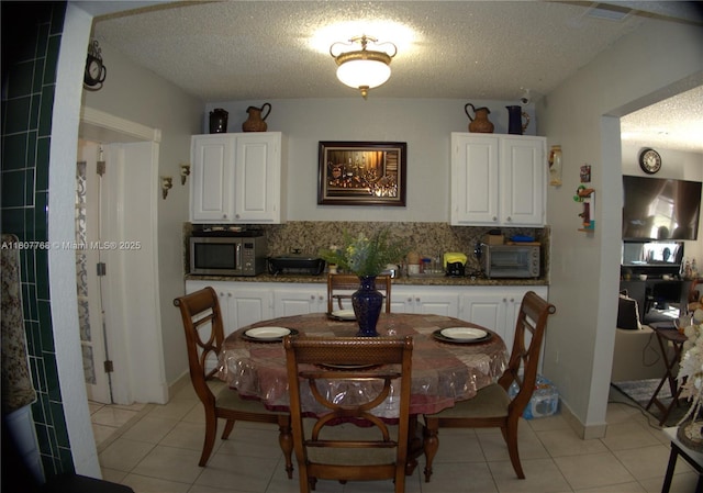 10321 Fairway Heights Blvd, Miami, FL 33157 - dining room with light tile patterned floors and a textured ceiling