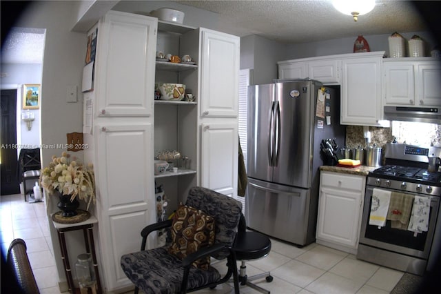 10321 Fairway Heights Blvd, Miami, FL 33157 - kitchen featuring appliances with stainless steel finishes, under cabinet range hood, light tile patterned floors, open shelves, and white cabinetry