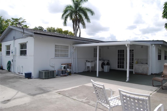 10321 Fairway Heights Blvd, Miami, FL 33157 - rear view of property with cooling unit, a patio area, stucco siding, separate washer and dryer, and a sink