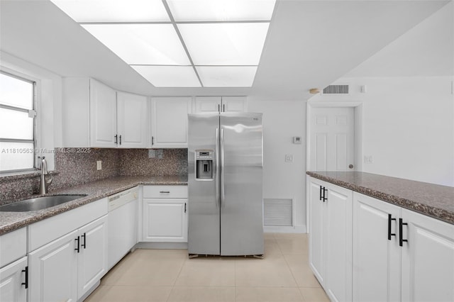 3202 SW 3rd St, Miami, FL 33135 - kitchen with stainless steel refrigerator with ice dispenser, white dishwasher, a sink, light tile patterned floors, and white cabinetry